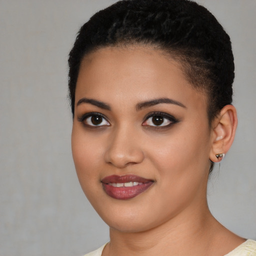 Joyful latino young-adult female with short  black hair and brown eyes