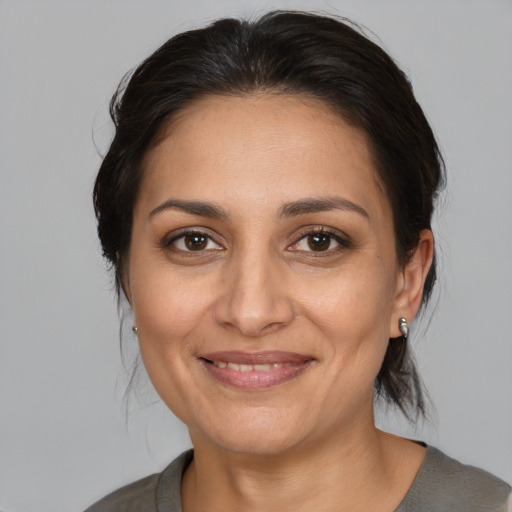 Joyful white adult female with medium  brown hair and brown eyes