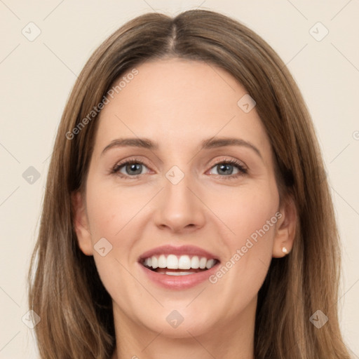 Joyful white young-adult female with long  brown hair and green eyes