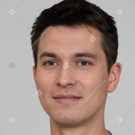 Joyful white young-adult male with short  brown hair and brown eyes