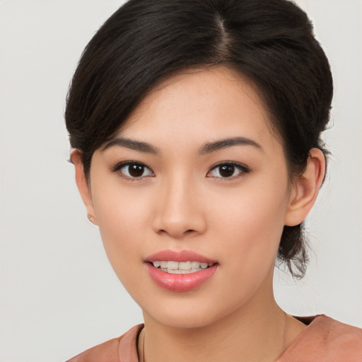 Joyful asian young-adult female with short  brown hair and brown eyes