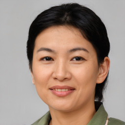 Joyful asian adult female with medium  brown hair and brown eyes