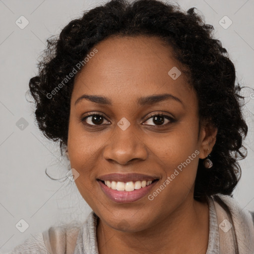 Joyful black young-adult female with long  brown hair and brown eyes