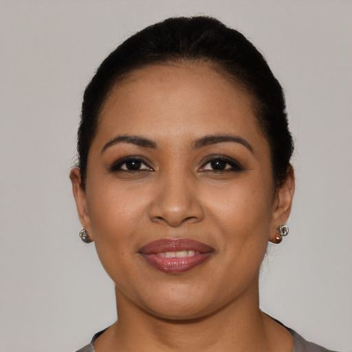 Joyful latino young-adult female with short  black hair and brown eyes