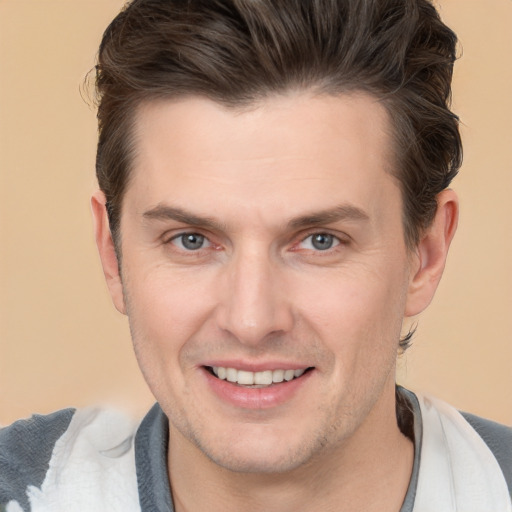 Joyful white adult male with short  brown hair and brown eyes