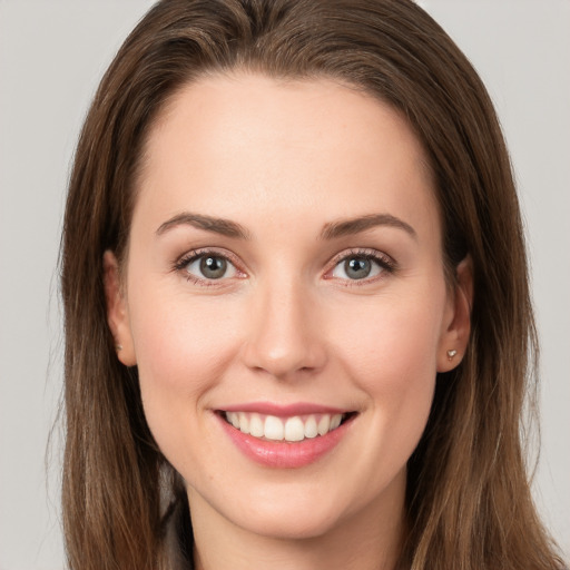 Joyful white young-adult female with long  brown hair and grey eyes