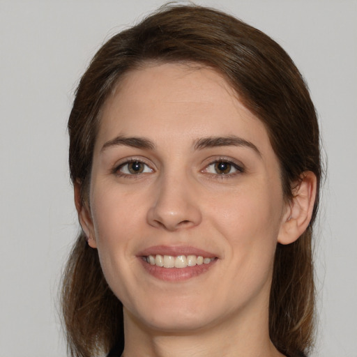 Joyful white young-adult female with medium  brown hair and brown eyes