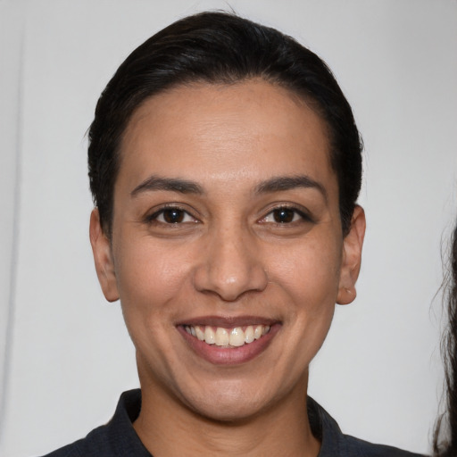 Joyful white young-adult female with short  black hair and brown eyes