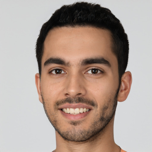 Joyful white young-adult male with short  black hair and brown eyes