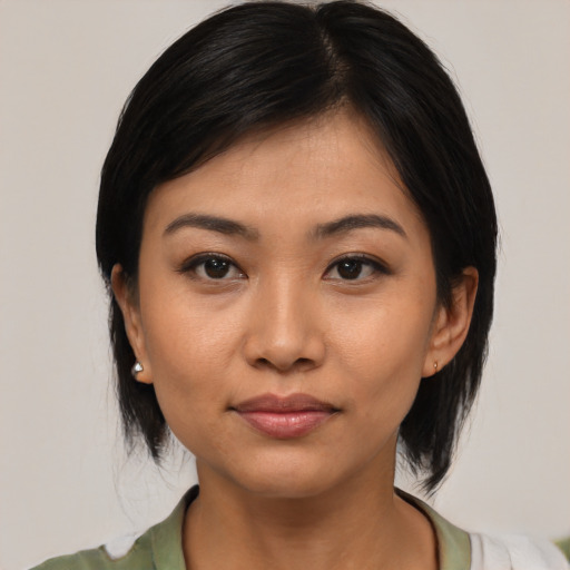 Joyful asian young-adult female with medium  black hair and brown eyes