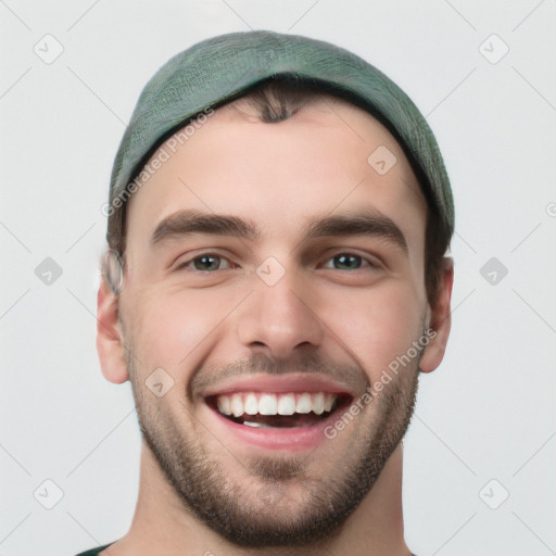 Joyful white young-adult male with short  black hair and brown eyes