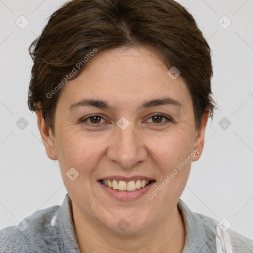 Joyful white adult female with short  brown hair and brown eyes