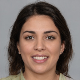 Joyful white young-adult female with medium  brown hair and brown eyes