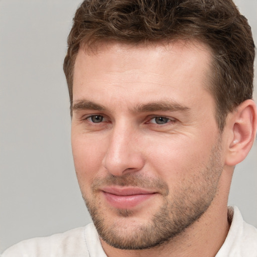 Joyful white young-adult male with short  brown hair and brown eyes