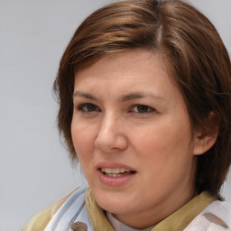 Joyful white young-adult female with medium  brown hair and blue eyes