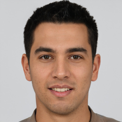Joyful white young-adult male with short  black hair and brown eyes