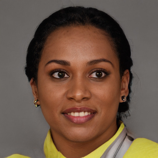 Joyful black young-adult female with short  brown hair and brown eyes