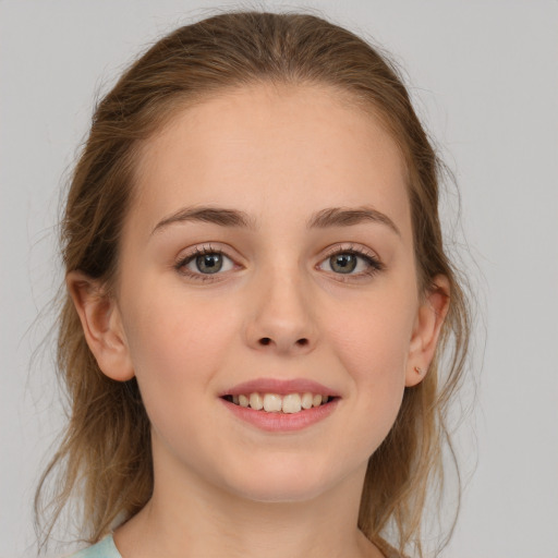 Joyful white young-adult female with medium  brown hair and grey eyes