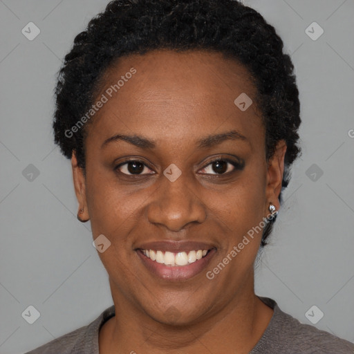 Joyful black young-adult female with short  black hair and brown eyes