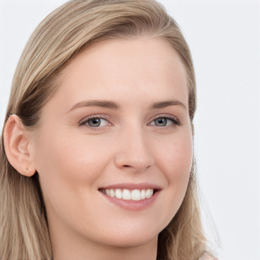 Joyful white young-adult female with long  brown hair and blue eyes