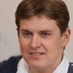 Joyful white adult male with short  brown hair and brown eyes