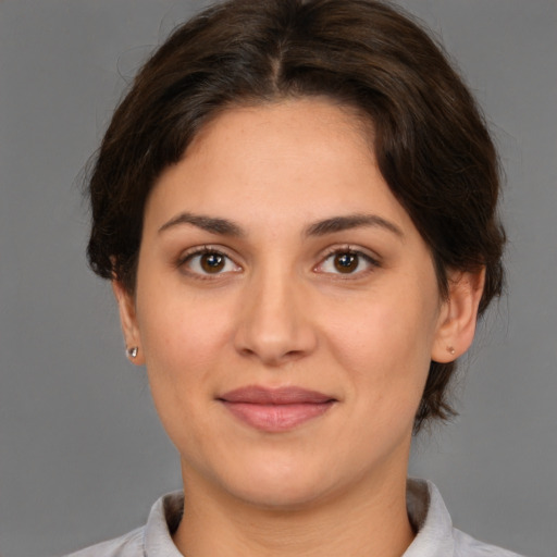 Joyful white adult female with medium  brown hair and brown eyes