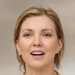 Joyful white adult female with medium  brown hair and grey eyes