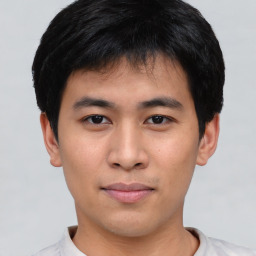 Joyful asian young-adult male with short  black hair and brown eyes