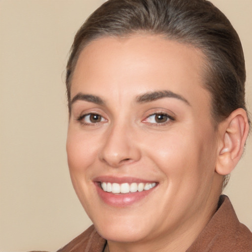 Joyful white young-adult female with short  brown hair and brown eyes