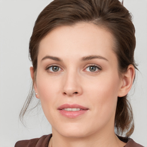 Joyful white young-adult female with medium  brown hair and blue eyes