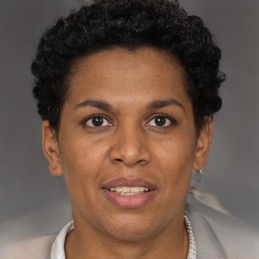 Joyful black adult female with short  brown hair and brown eyes