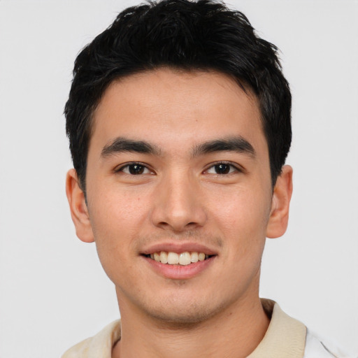 Joyful asian young-adult male with short  brown hair and brown eyes