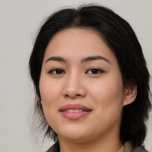 Joyful asian young-adult female with medium  brown hair and brown eyes