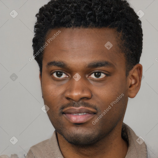 Joyful black young-adult male with short  brown hair and brown eyes