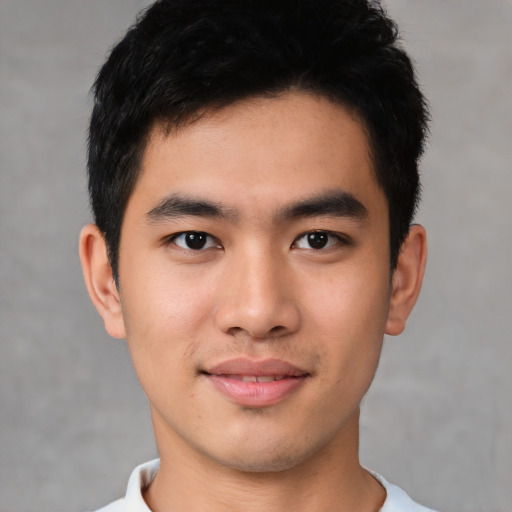 Joyful asian young-adult male with short  brown hair and brown eyes