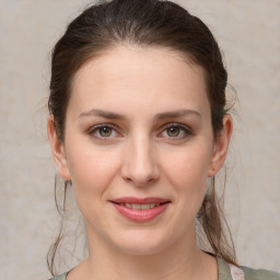 Joyful white young-adult female with medium  brown hair and grey eyes