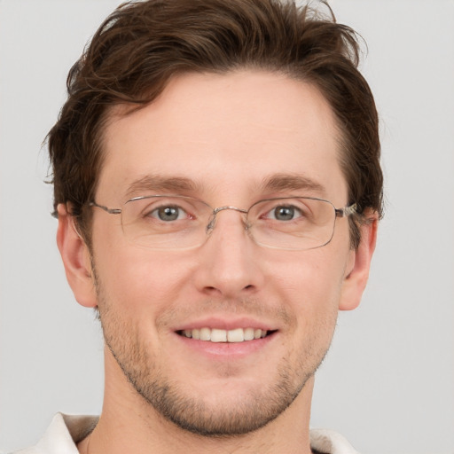 Joyful white adult male with short  brown hair and grey eyes