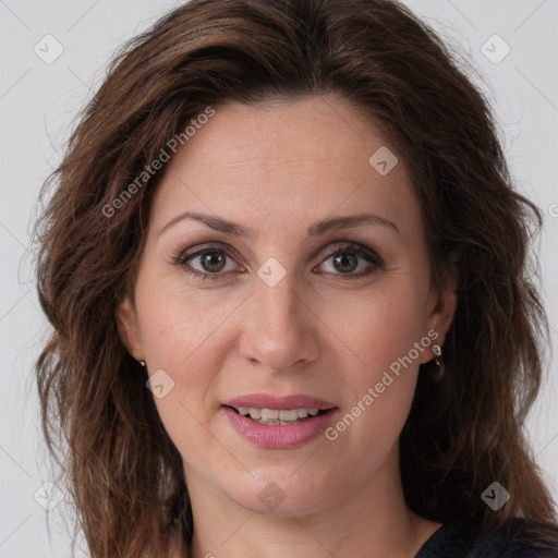 Joyful white adult female with long  brown hair and brown eyes