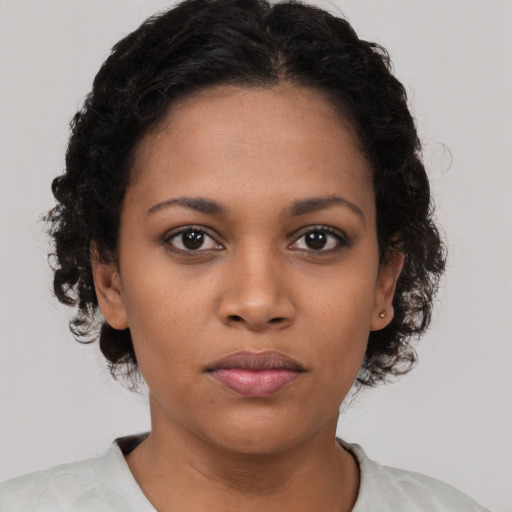 Neutral black young-adult female with medium  brown hair and brown eyes