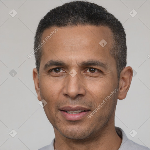 Joyful latino adult male with short  black hair and brown eyes