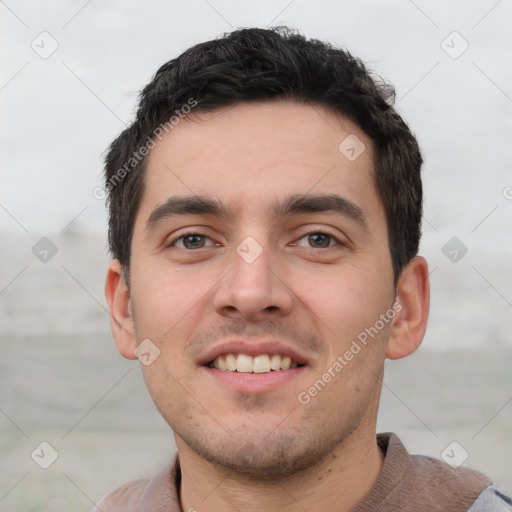 Joyful white young-adult male with short  black hair and brown eyes