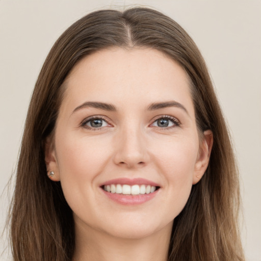 Joyful white young-adult female with long  brown hair and grey eyes