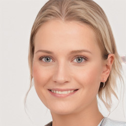 Joyful white young-adult female with medium  brown hair and blue eyes