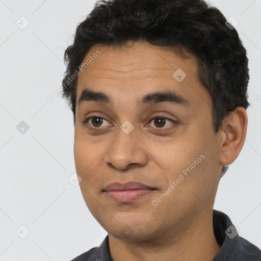 Joyful latino young-adult male with short  brown hair and brown eyes