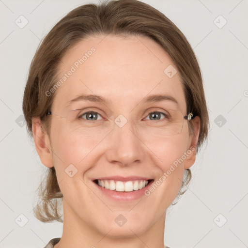 Joyful white adult female with medium  brown hair and grey eyes