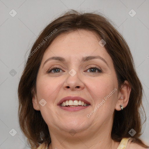 Joyful white adult female with medium  brown hair and grey eyes