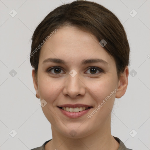 Joyful white young-adult female with short  brown hair and grey eyes