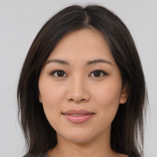 Joyful asian young-adult female with medium  brown hair and brown eyes
