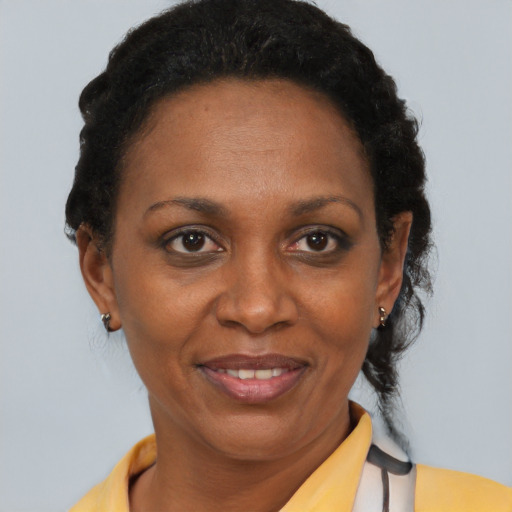 Joyful black adult female with short  brown hair and brown eyes