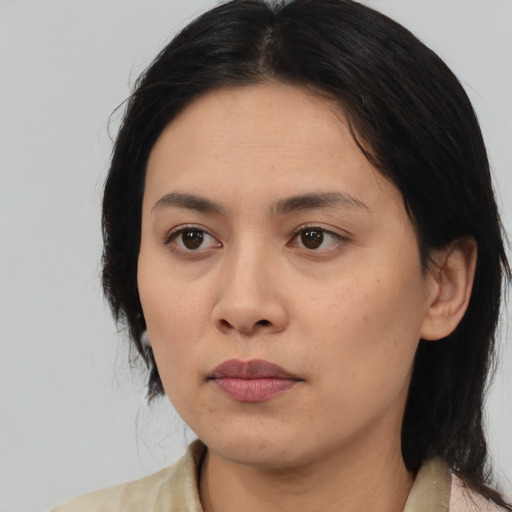 Neutral asian adult female with medium  black hair and brown eyes